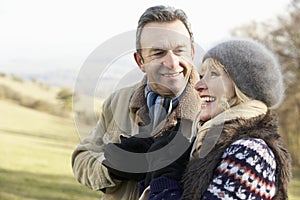 Mature couple on country walk in winter