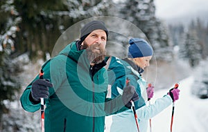 Mature couple cross country skiing outdoors in winter nature, Tatra mountains Slovakia.