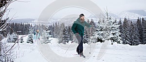 Mature couple cross country skiing outdoors in winter nature, Tatra mountains Slovakia.