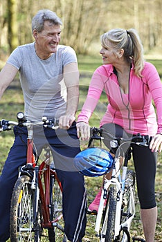 Mature Couple On Cycle Ride In Countryside Together