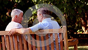 Mature couple discussing together on a bench