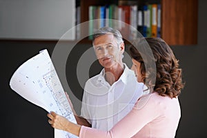 Mature couple, documents and blueprint with renovation in maintenance or interior design at house. Creative man or woman