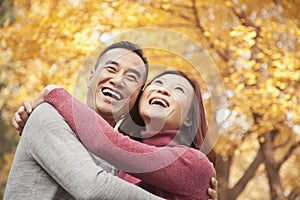 Mature Couple Embracing in Park