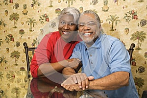 Mature couple embracing and smiling.