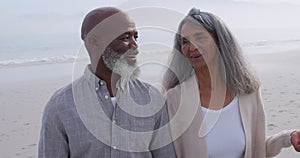 Mature couple enjoying time outside by the sea