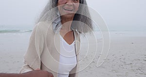 Mature couple enjoying time outside by the sea