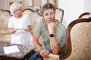 Mature couple fighting over documents, relationship problems