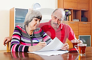 Mature couple fills in questionnaire together