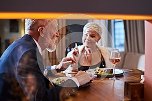 Mature couple fine dining food in hotel or elegant expensive restaurant