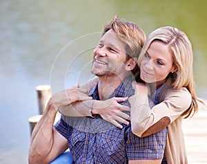 Mature couple, happiness and vacation in lake, countryside and commitment with love in marriage. Anniversary, smile and