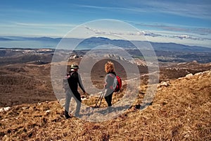 Mature couple hiking in the mountains and looking at the view