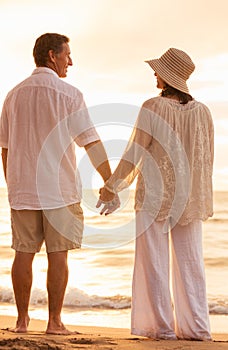 Mature Couple Holding Hands Enjoying at Sunset