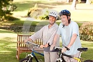 Mature couple holding their bikes