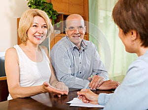 Mature couple with insurance agent