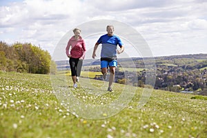 Mature Couple Jogging In Countryside