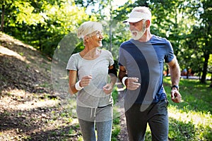Mature couple jogging and running outdoors in city