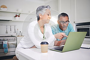 Mature couple, laptop and pointing for internet connection, communication or social media post. A man and woman talking