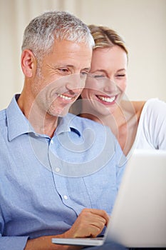Mature couple, laptop and smiling with video call, conversation and living room couch. Social media, technology and
