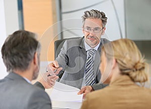 Mature couple in lawyer's office asking advice