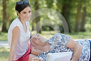 mature couple laying on blanket