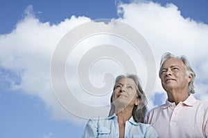 Mature Couple Looking Up Against Sky