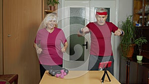 Mature couple man and woman fitness trainer coach records video online workout exercises course
