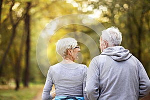 Mature couple man and woman jogging in park