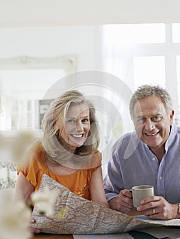 Mature couple With Map At Home