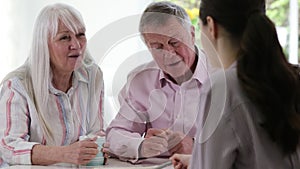 Mature Couple Meeting With Female Financial Advisor