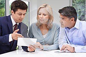 Mature Couple Meeting With Financial Advisor At Home