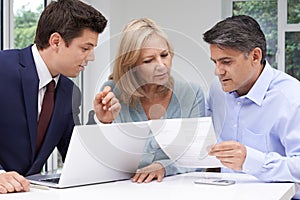 Mature Couple Meeting With Financial Advisor At Home