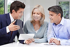 Mature Couple Meeting With Financial Advisor At Home