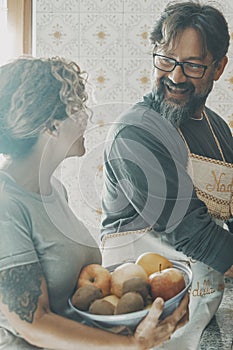 Mature couple man and woman doing housework together with happiness and enjoying life married or in relationship. Man washing