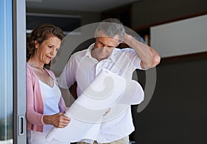 Mature couple, planning and interior design with blueprint or documents for maintenance or renovation at house. Creative