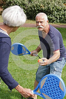 mature couple playing tennis