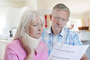 Mature Couple Reading Letter About Wife`s Injury