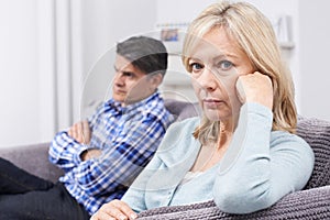 Mature Couple With Relationship Difficulties Sitting On Sofa