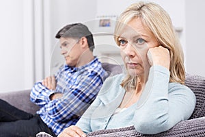 Mature Couple With Relationship Difficulties Sitting On Sofa photo