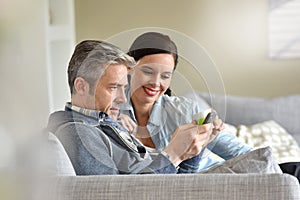 Mature couple relaxing in sofa photo