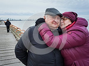 Mature couple resting by the sea in winter