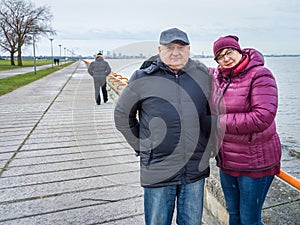Mature couple resting by the sea in winter