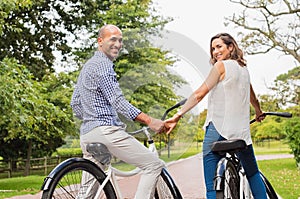 Mature couple riding bicycle