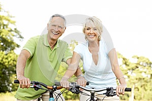 Mature couple riding bikes