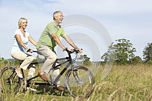 Mature couple riding tandem