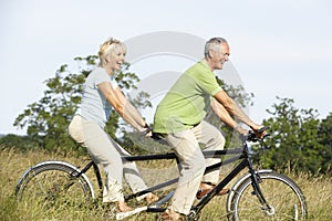 Mature couple riding tandem