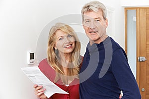 Mature Couple Saving Money On Domestic Heating Bills