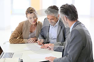 Mature couple signing contract