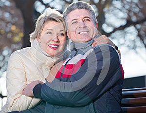 Mature couple sitting on park bench