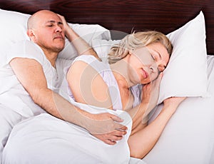 Mature couple sleeping in bed