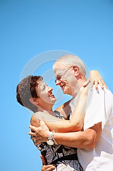 Mature couple smiling and embracing